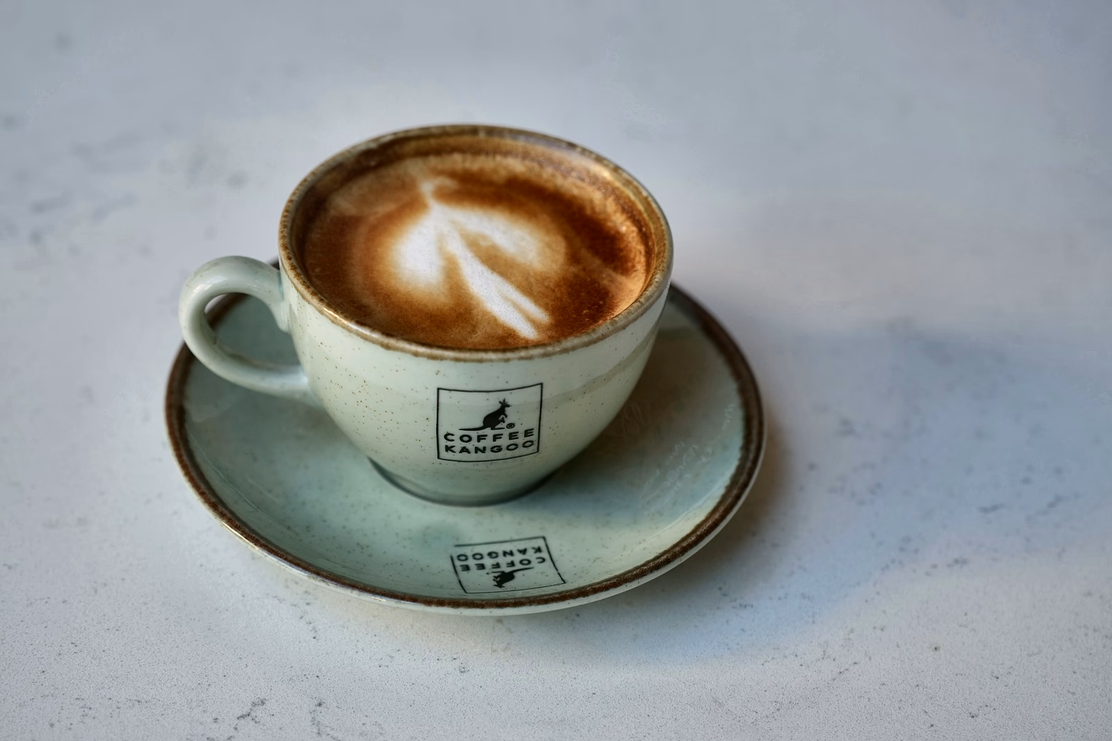 Coffee with milk foam in a ceramic cup.
