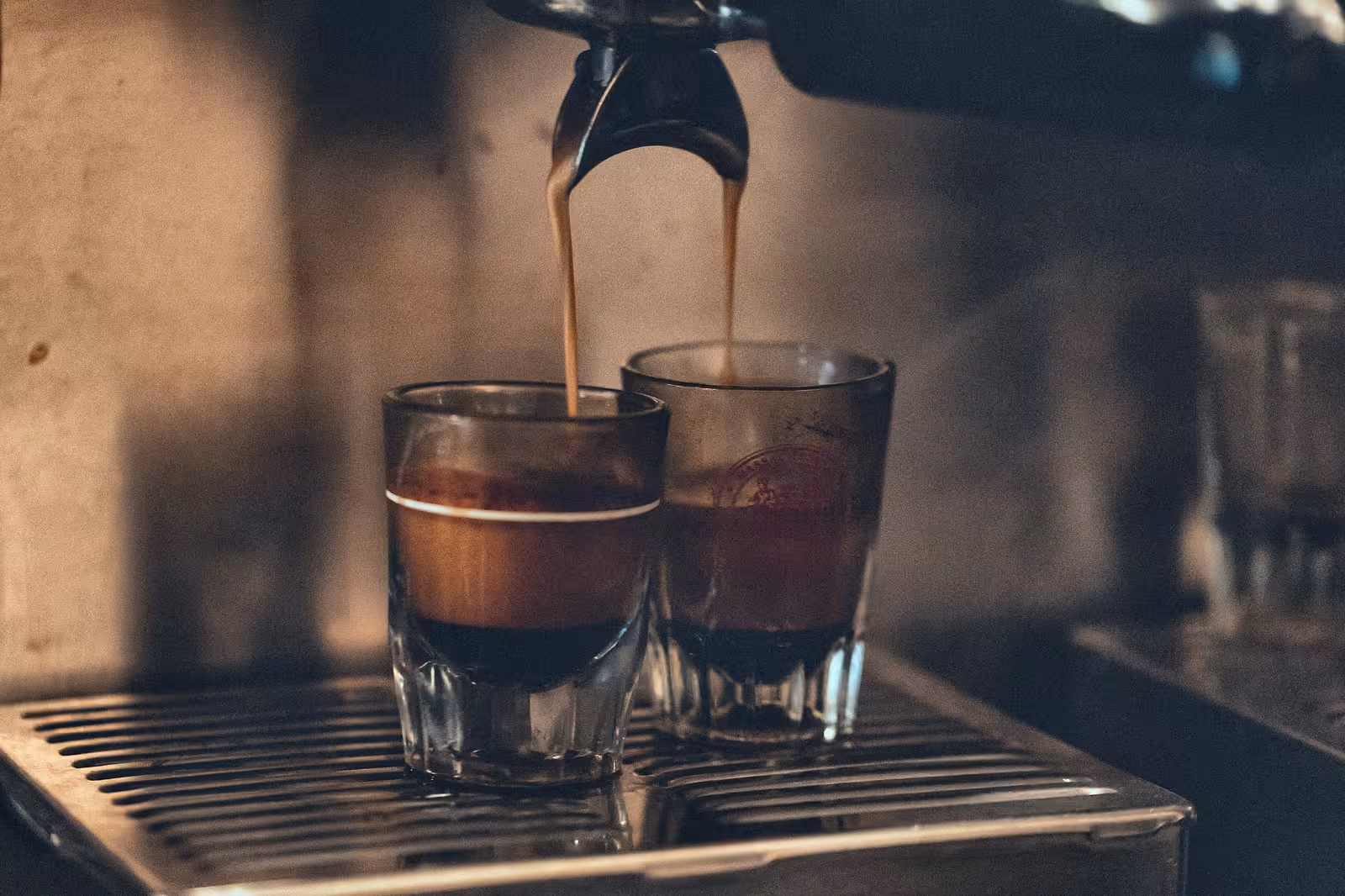 Two dark espresso shots with a layer of crema.